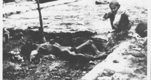 A murdered Armenian man lies in a ditch as a  child watches the corpse