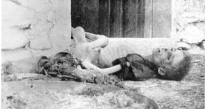 An emaciated Armenian boy lies dead on a doorstep. Photograph - Armin Wegner