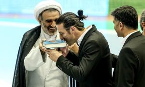 Ando kissing the Quran