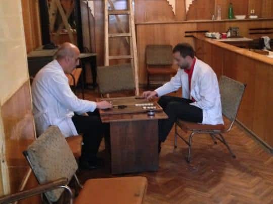 Two barbers take a break with some backgammon.