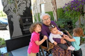 Armenian Genocide survivor Yevnige Salibian poses for a photo with her great-grandchildren Vaughn Bahadarian, left, Aykienne Kiledjian and Brielle Bahadarian following a memorial service and the unveiling of a Armenian Genocide monument at the Ararat Home of Los Angeles on March 12, 2015. Salibian died Aug. 29, 2015 at the age of 101.