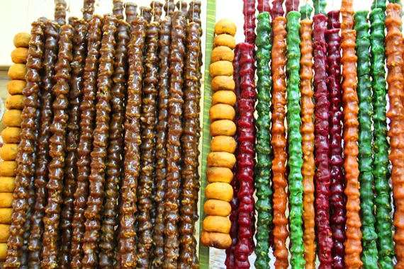 Strings of dried fruits hang in the covered market