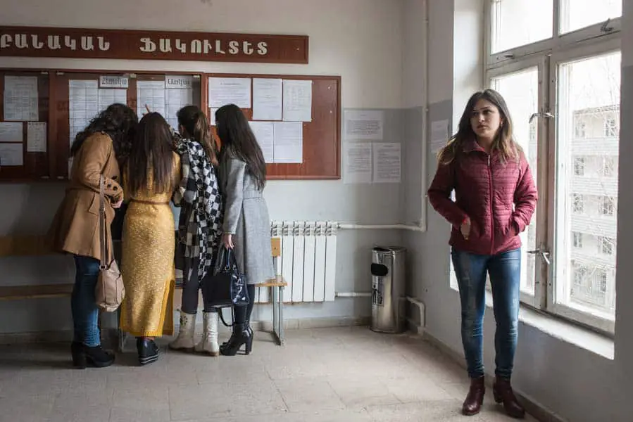A group of female students check their class schedule during a break at Artsakh State University in the NKR. A degree here will only have value in the NKR and Armenia, since the NKR's self-declared independence has not been recognized by neighboring countries. KARL MANCINI, GIANMARCO MARAVIGLIA/ECHO