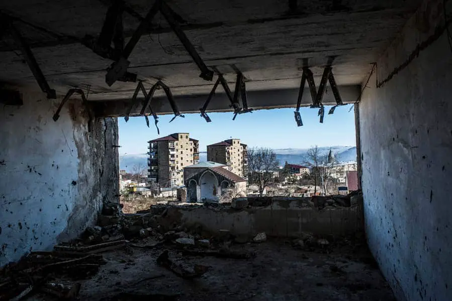 Intact buildings stand among heavily damaged buildings in the city center of Shushi. The city came under control of the NKR in 1992 after heavy fighting and has experienced little to no rebuilding, still bearing deep scars of war. KARL MANCINI, GIANMARCO MARAVIGLIA/ECHO
