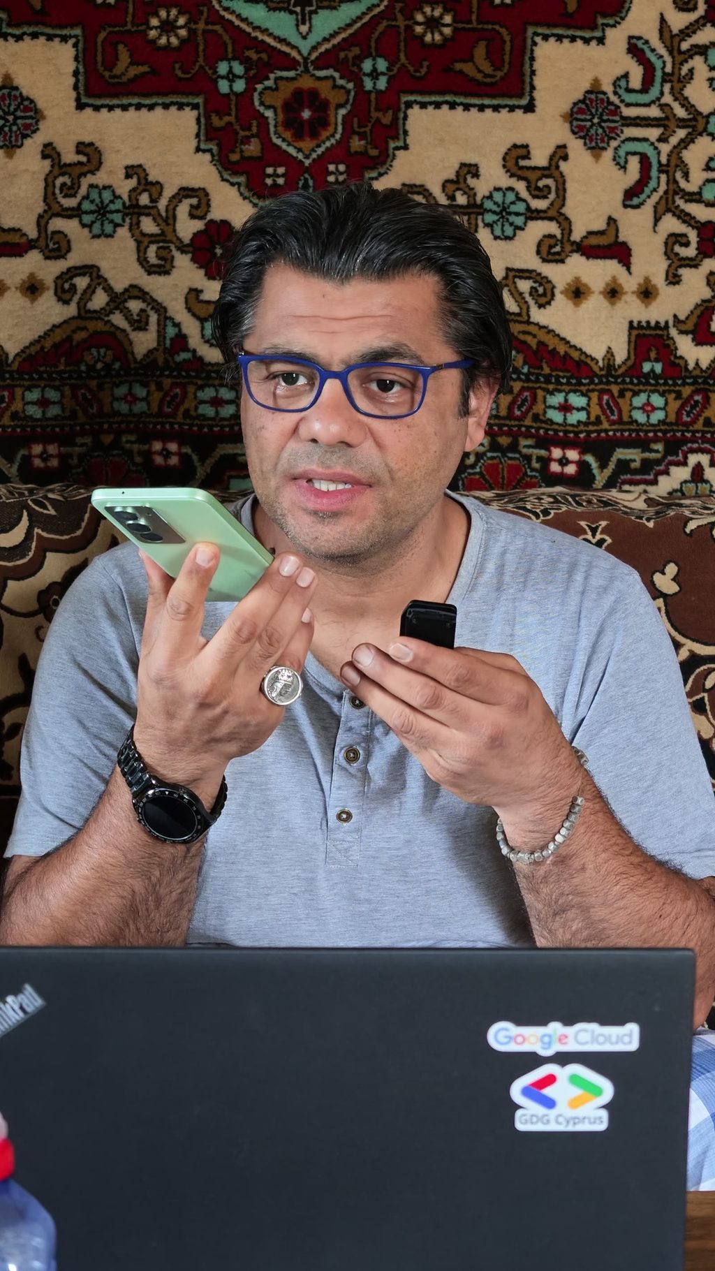 A phone held up on a Gyumri street, an Armenian-language answer on the screen.