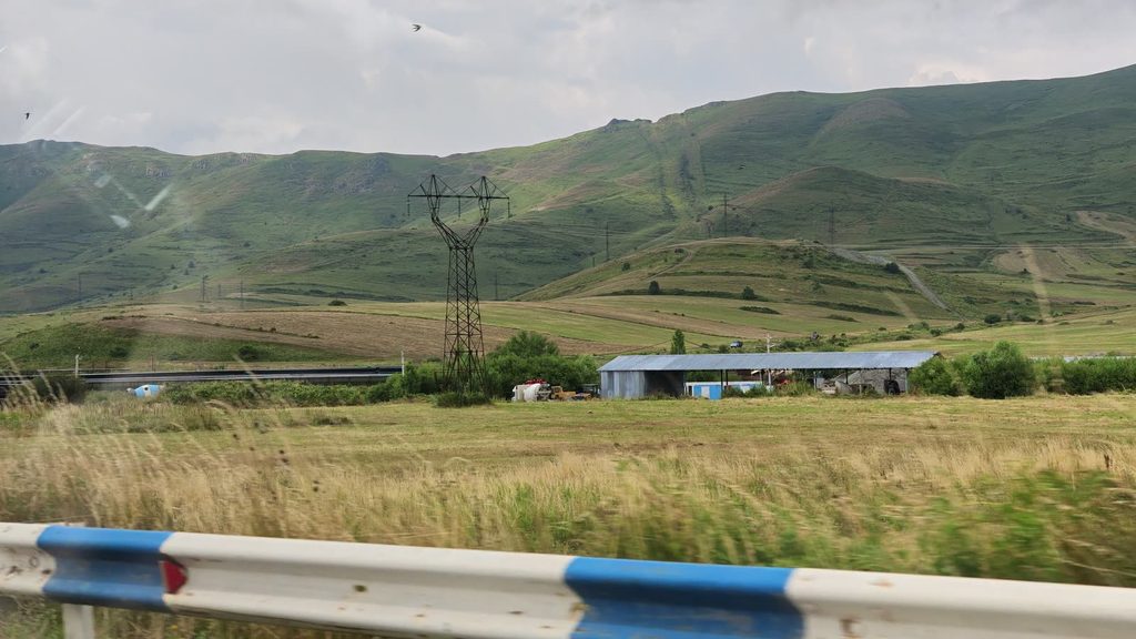 The road descending from Ijevan into a wide green valley.