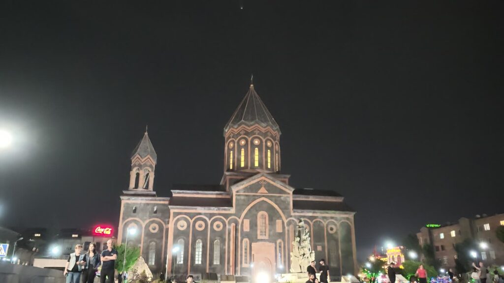 The church from behind, lit from below.