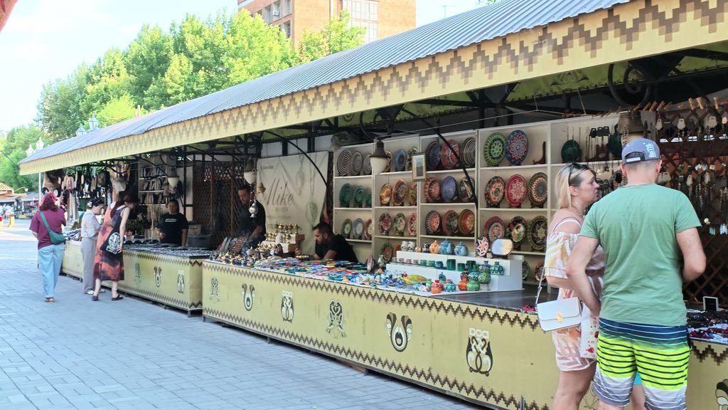 An aisle of stalls at the Vernissage open-air market.