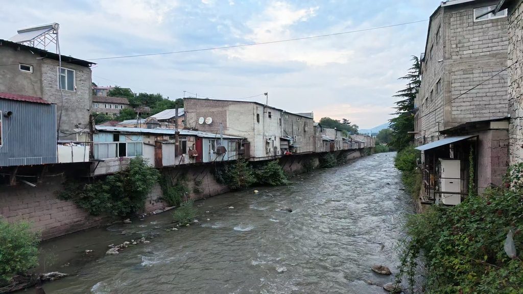 Houses on stilts and balconies overhanging the river in Ijevan.