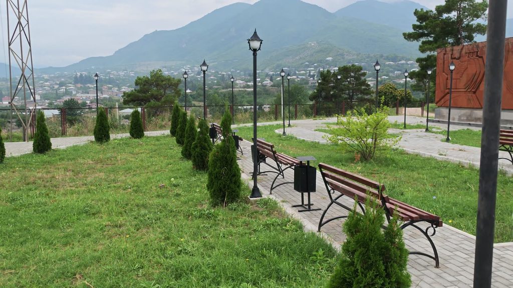 Ranges of the Tavush mountains receding in layers behind the monument.