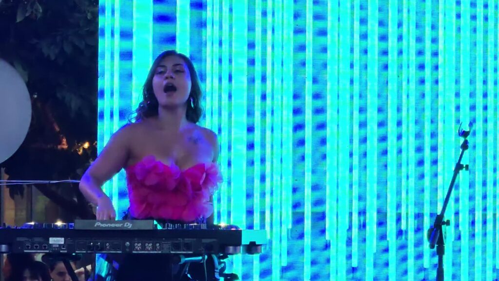 DJ Sianna, against a curtain of lights.