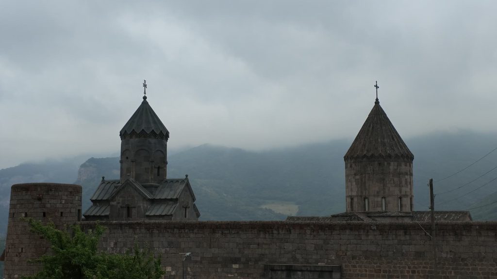The domes of Tatev monastery in soft evening light.